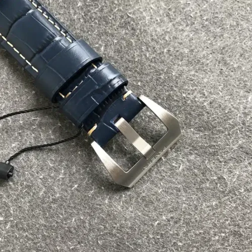 Brushed tang buckle on blue alligator-pattern leather, black tag cord