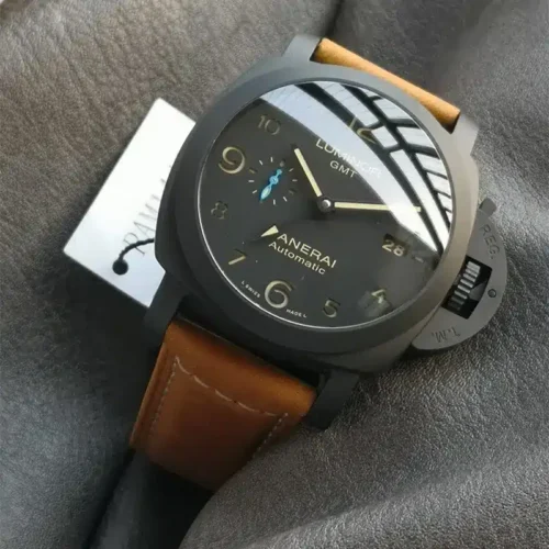 Glare across the black GMT dial, paper tag tucked beside the case