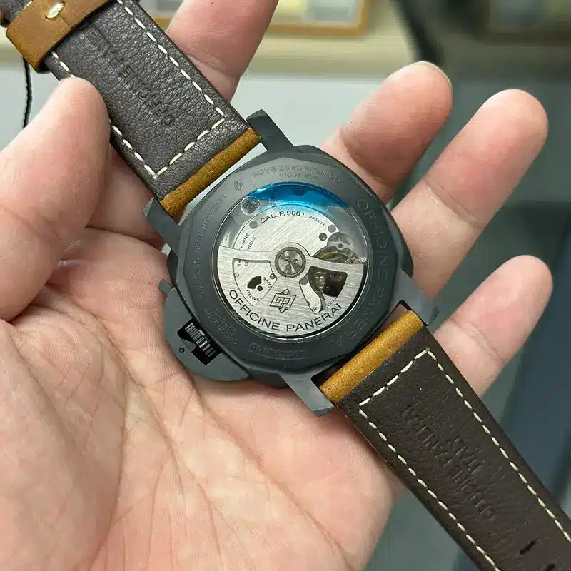 Display back resting in the palm, movement visible under blue film