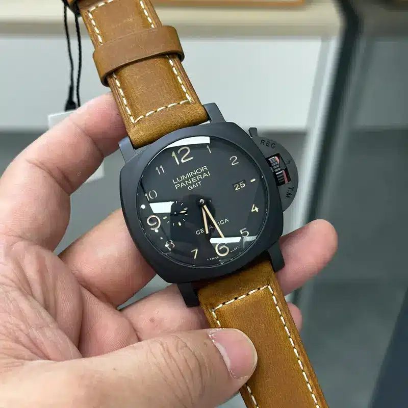 Black case tilted to the left, small seconds and Ceramica print visible
