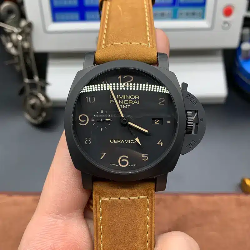 Luminor 1950 GMT PAM441 held up in front of a timing machine