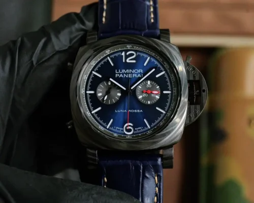 Held in a black glove, blue dial on a croc-pattern blue strap