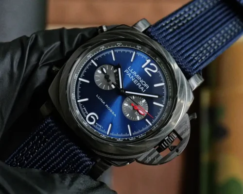 Case rotated clockwise, crown guard at the bottom, blue sunburst dial
