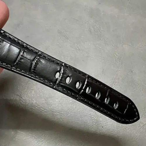 Black strap tip with embossed scale pattern and grey stitching