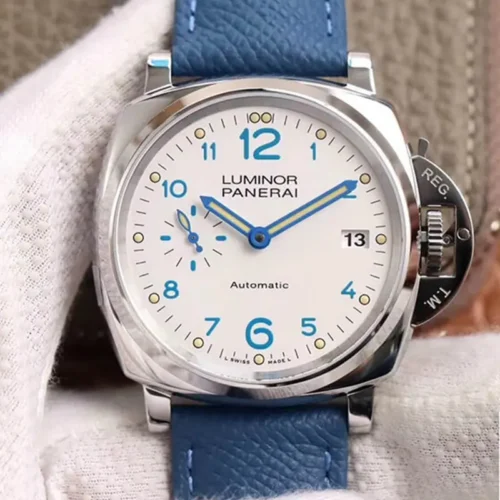 White dial photographed on a cotton glove, turquoise numerals and date window