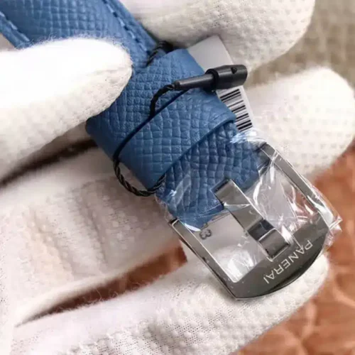 Polished Panerai pin buckle still in film, blue grained strap and tag