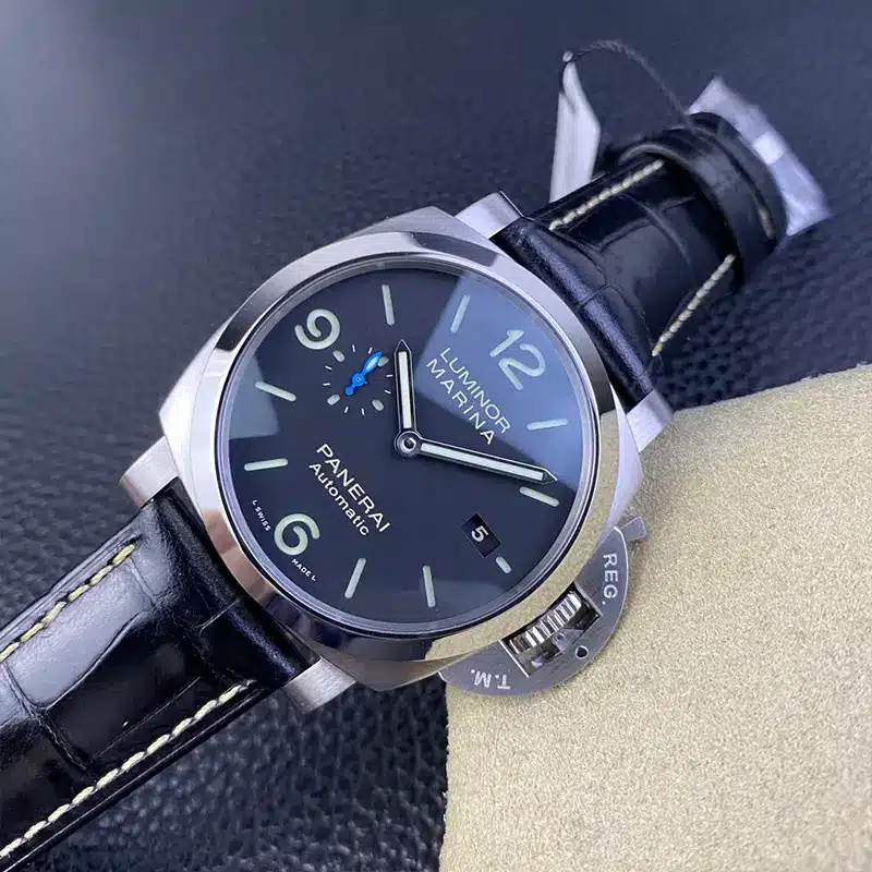Low angle across the polished bezel, REG T.M. lever at lower right