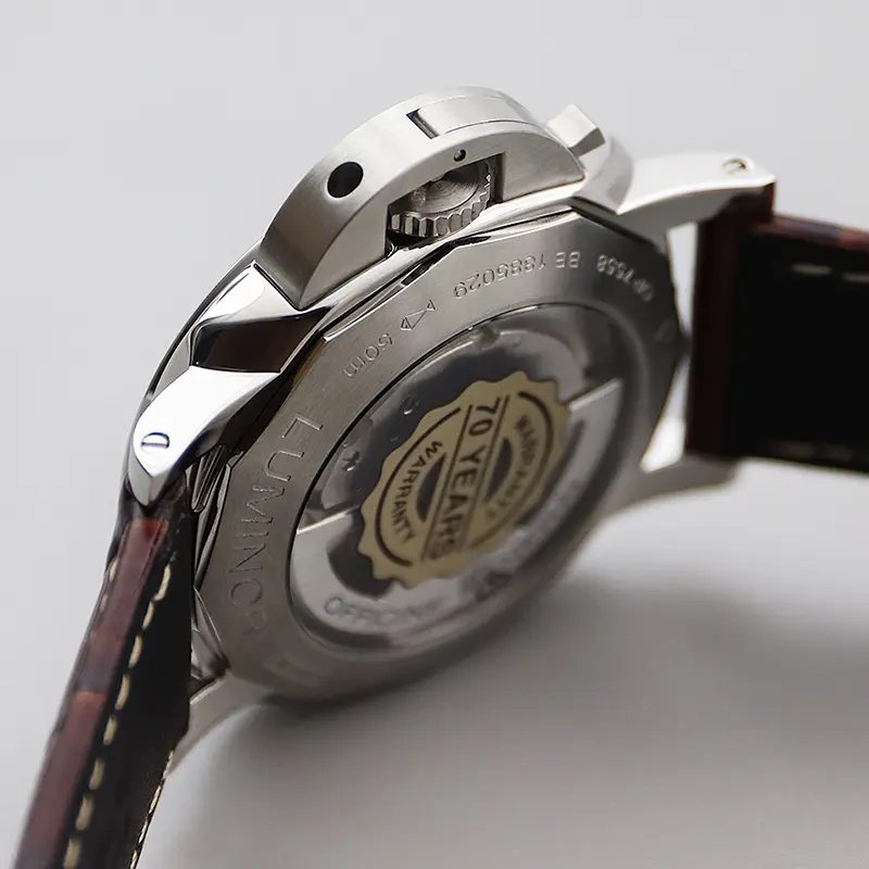 Display caseback seen from the crown side, a round sticker on the glass