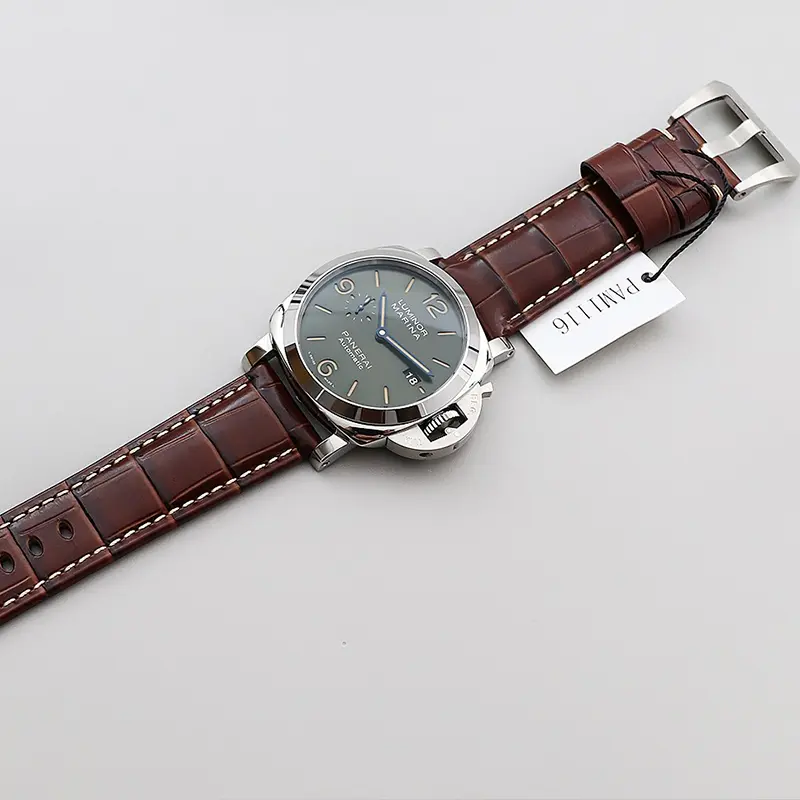 Luminor Marina PAM1116 laid flat on its full strap beside a reference tag