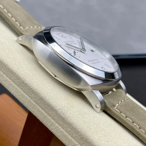 Brushed left side of the case and polished bezel on a cream stand