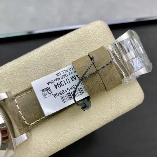 Polished pin buckle wrapped in film, tag tied around the keeper