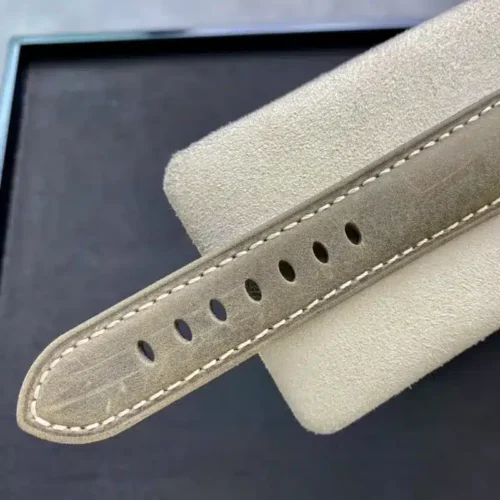 Khaki suede strap tail, cream stitching and a row of holes