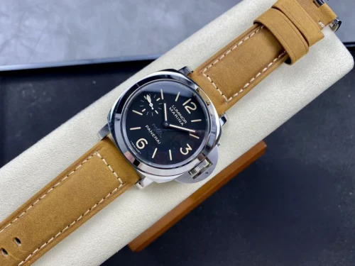Entire watch stretched over the cushion, tan strap running across the box
