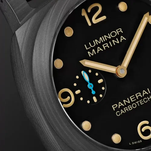 Close crop of the 12, gold tone hands and grained bezel