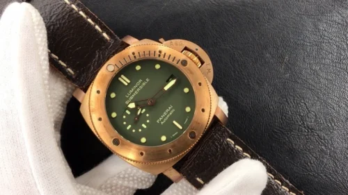 Watch angled across the glove on black leather, crown guard top right
