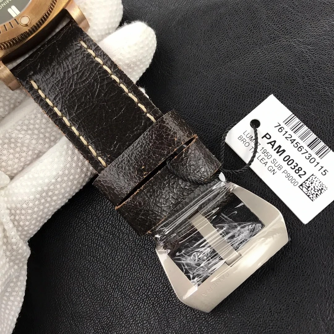 Buckle sealed in clear film, barcode tag on a black cord over cracked leather