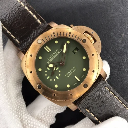 Luminor Submersible PAM382 in a white glove, olive dial and bronze tone bezel