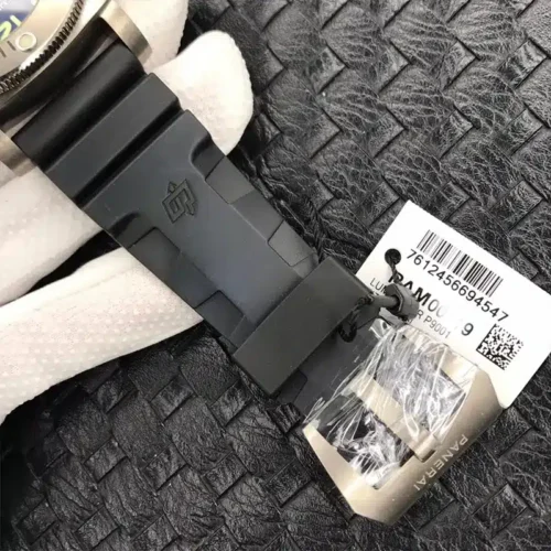 Brushed buckle wrapped in film beside a barcode hang tag