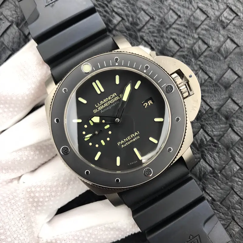 Tilted shot of the matte black dial, date at 3 and baton markers