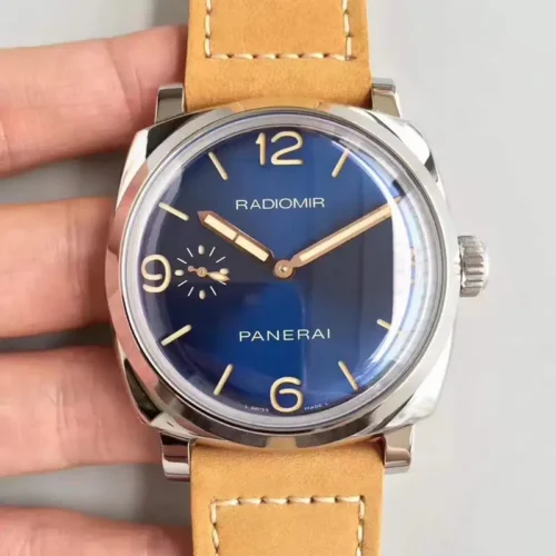 Hand-held front shot of the blue dial, numerals at 12, 3, 6 and 9