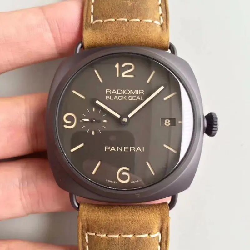 Brown dial held face on, beige numerals at 12, 6 and 9