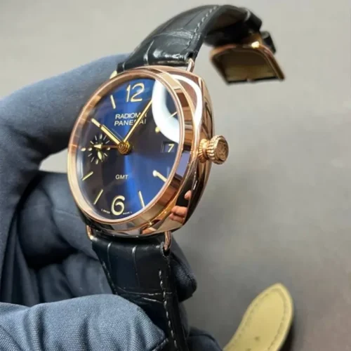 Blue dial at an angle with gold hands and the GMT arrow