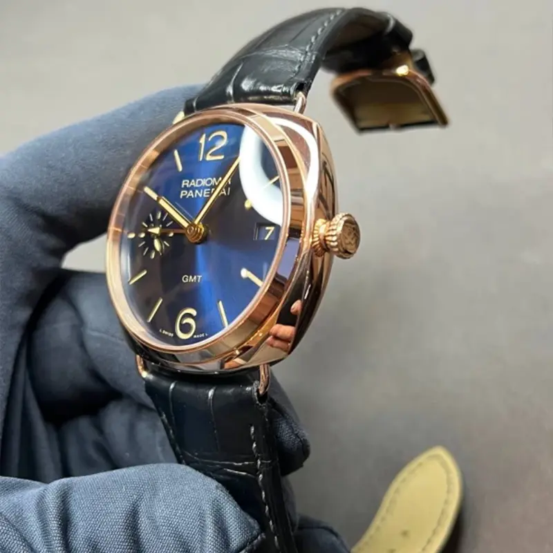 Blue dial at an angle with gold hands and the GMT arrow