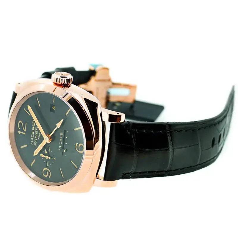 Rose gold tone case on its side beside a folding clasp, black strap