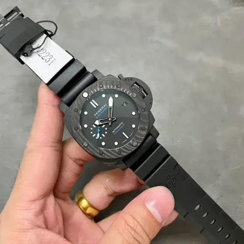 Submersible PAM2231 held by the strap, paper tag clipped to the rubber