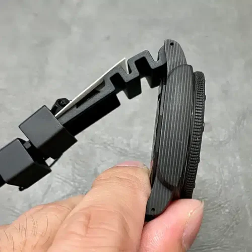 Marbled case and bezel edge held sideways between the fingers