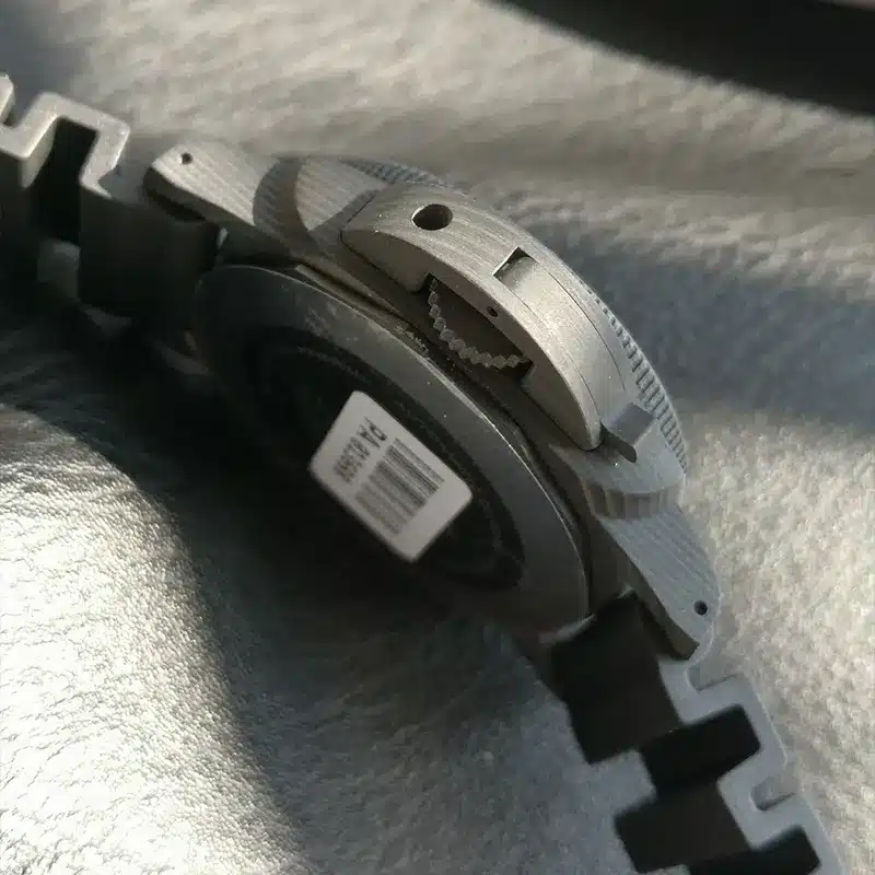 Barcode sticker on the back, seen past the crown guard from below
