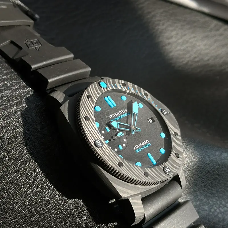 Dial seen from the 9 o'clock side, pale blue indices and hands