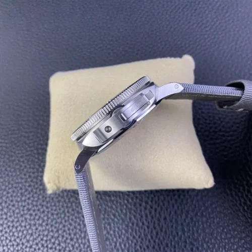 Crown side in profile, lever folded flat against the brushed case