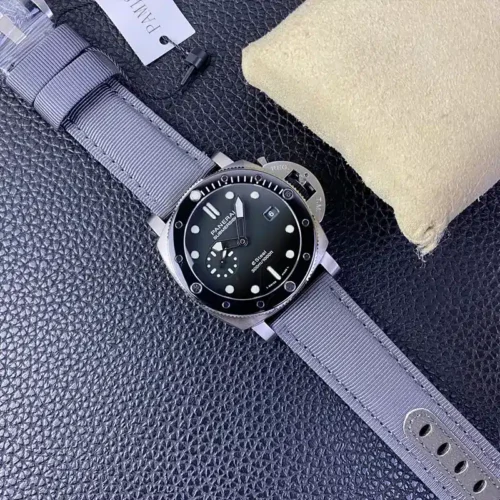 Whole watch angled across dark leather, grey strap and tag at the top