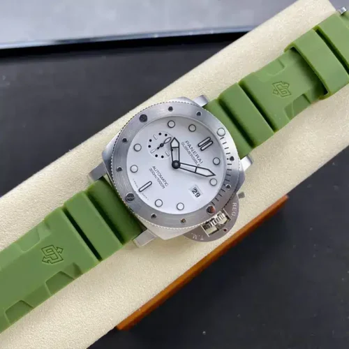 Whole watch laid diagonally across the cream stand, green strap running to the corners