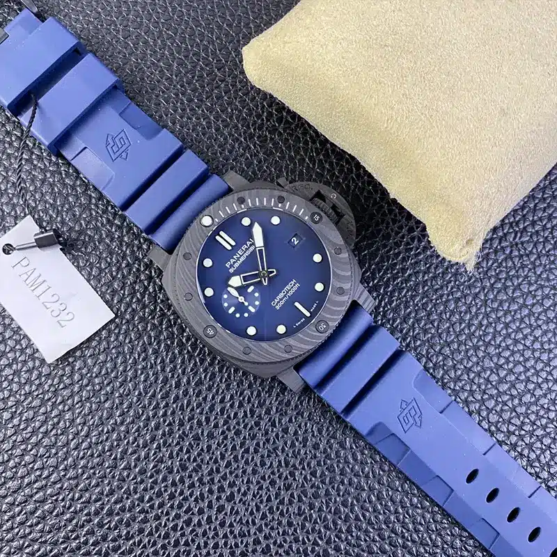 Full blue strap stretched across dark leather, hang tag beside the case