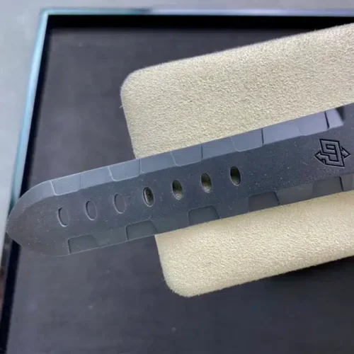 Rubber strap end on the cream stand, holes punched in a line