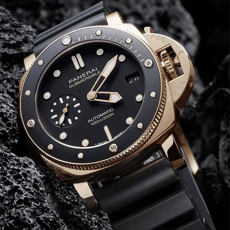Submersible PAM974 on dark porous rock, rose gold tone lugs and black dial
