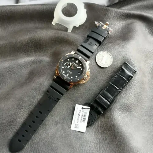 Submersible PAM974 with a spare black leather strap, a coin and its tag