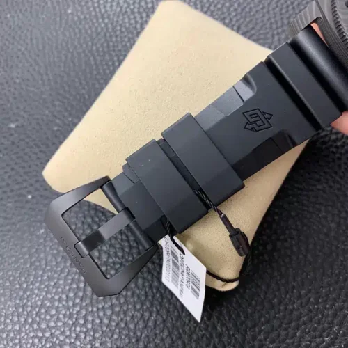 Matte black buckle with a barcode tag tied to the rubber strap