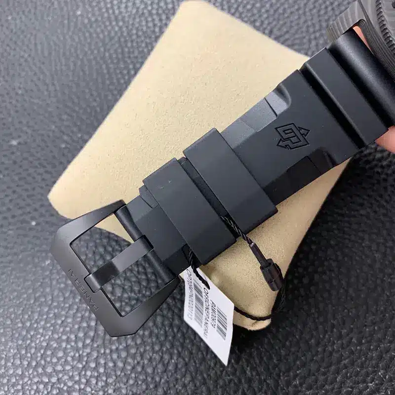 Matte black buckle with a barcode tag tied to the rubber strap