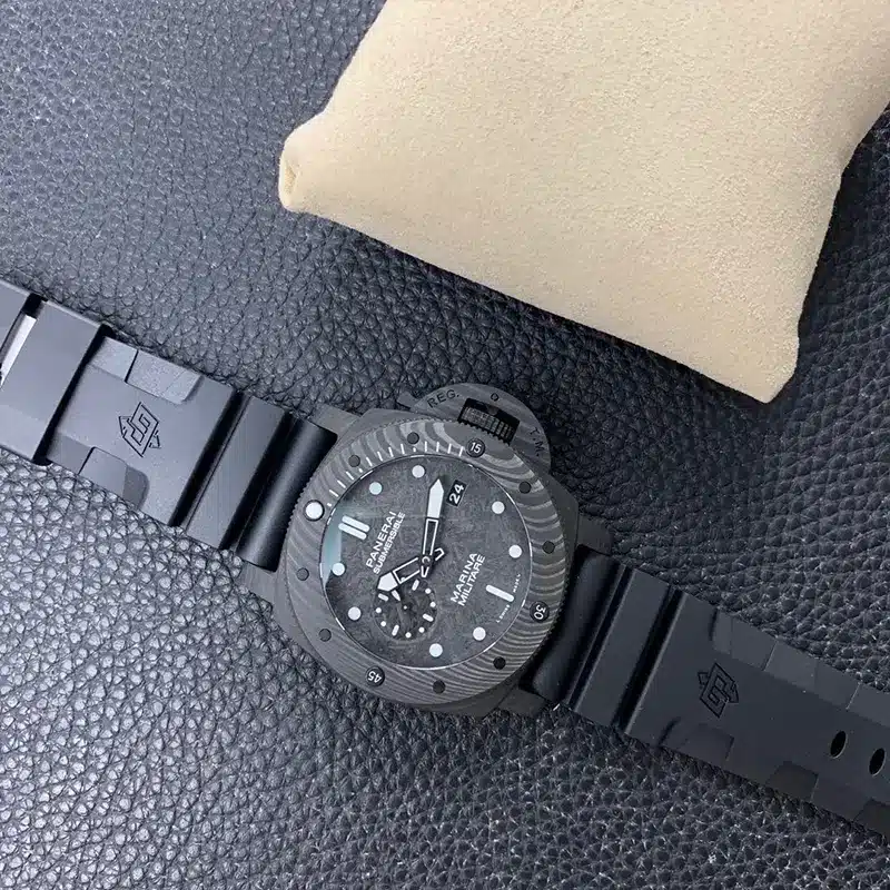 Whole watch on pebbled black leather, rubber strap with a raised emblem