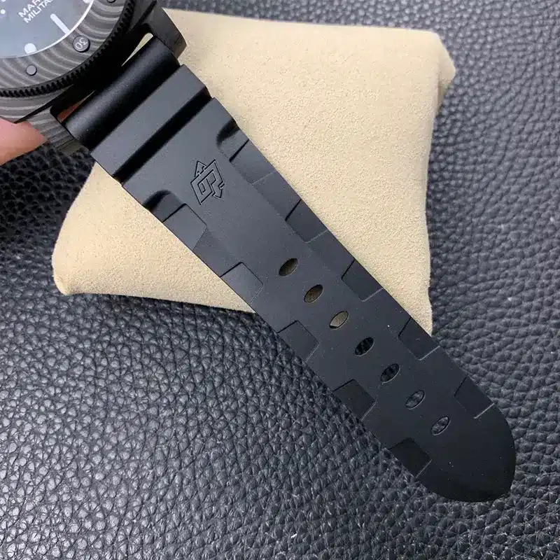 Underside of the black rubber strap, row of holes and raised logo