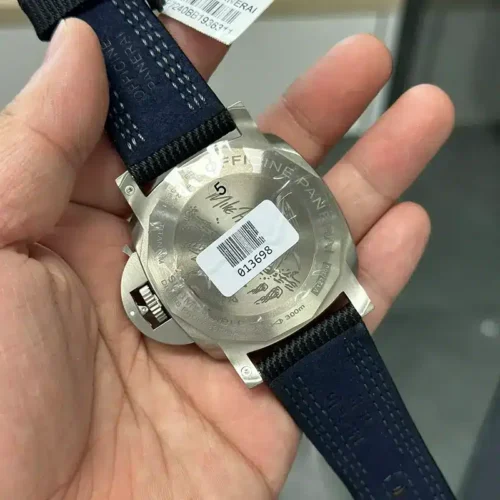 Engraved back with a signature, barcode sticker on the film, blue strap lining