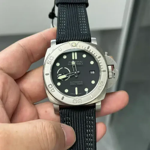 Held in the fingers, dark grey dial with green lume and the 18 date