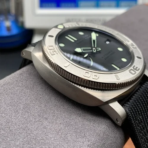 Left flank and knurled bezel edge, a timing machine screen behind