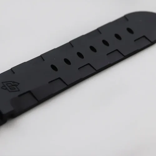 Black rubber strap end, oval holes in a line and a moulded logo